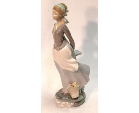 Lladro porcelain figure of a girl, blue printed marks, 36cm high.