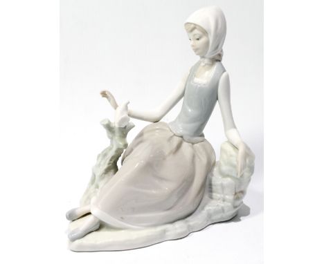 Lladro figure of a seated girl with a dove.