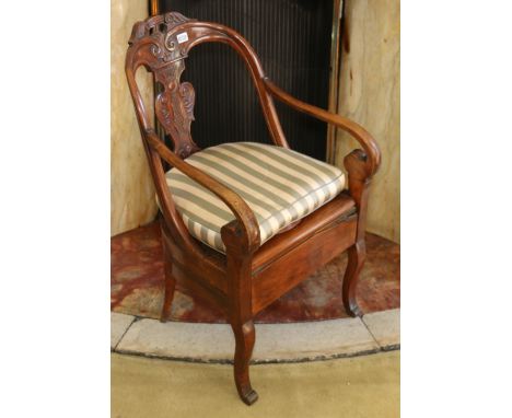 19th century French Empire style commode chair with leaf carved baluster splat, scroll arms on scrolling sabre supports, toge