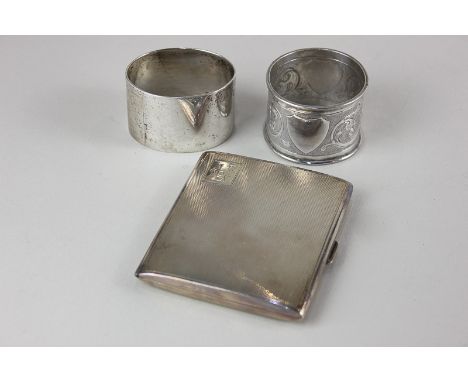 A George V silver gilt cigarette case, with engine-turned decoration, presented, Cohen &amp; Charles, London, 1932, together 