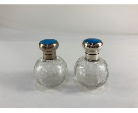 A pair of George V silver and blue guilloche enamel topped cut glass scent bottles, makers Mappin &amp; Webb, Birmingham, 191