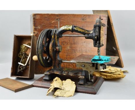 A VICTORIAN CAST IRON SEWING MACHINE, The Challenge by Joseph Harris of Birmingham, black painted with worn gilt decoration, 