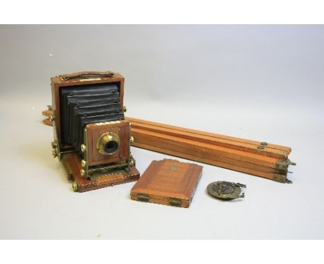 A J. LANCASTER & SONS 'LE MERITOIRE' QUARTER PLATE FOLDING FIELD CAMERA, constructed of mahogany and brass with a mahogany pl