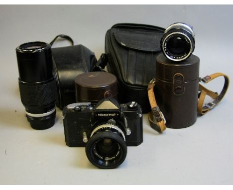 A NIKKORMAT FTN BLACK SLR CAMERA, fitted with a Nikkor S Auto 35mm 1:2.8 lens, a Nikkor Q Auto 135mm 1:3.5 lens, a Nikkor 80-