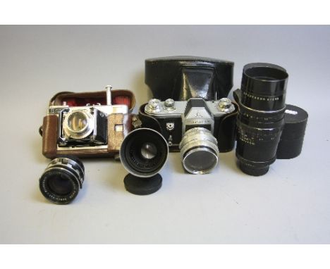 A ZEISS IKON VEB PENTACON SLR CAMERA, fitted with a CZ Jena 58mm 1:2 lens, a Voigtlander Vitessa L (type 140) camera, a Schne