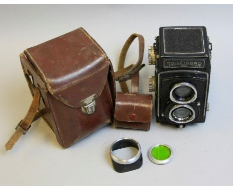 A ROLLEICORD 2 TLR CAMERA, with black face fitted with a CSJ Triotar 75mm 1:3.5 lens set, leather case, hood and filter inclu