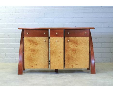 ▲ Andrew Varah (1944-2012), a burr maple and thuya wood inlaid sideboard, with a bow front, over a breakfront, centred with a