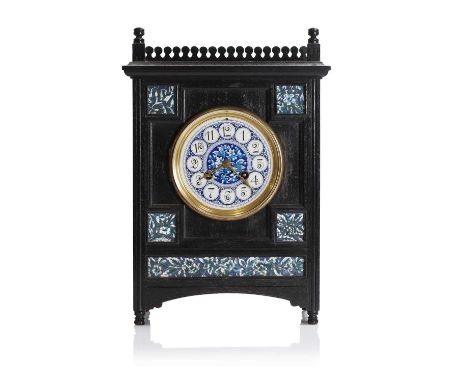 An Aesthetic Movement ebonised mantel clock, c.1880, attributed to Lewis Foreman Day (1845-1910), with a gilt-painted and ena
