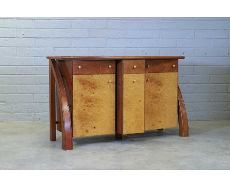 ▲ Andrew Varah (1944-2012), a burr maple and thuya wood inlaid sideboard, with a bow front, over a breakfront, centred with a