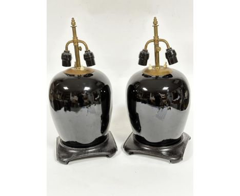 A pair of famille noir ginger jar style vase lamps with adjustable brass twin light fitting columns raised on ebonised square