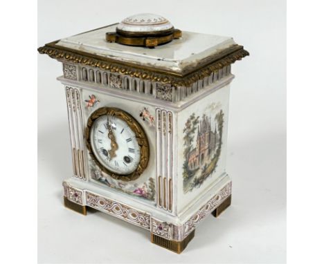 A French 19thc faience mantel clock with moulded top and ormolu mounted circular faience panel with enamel dial and twin key 