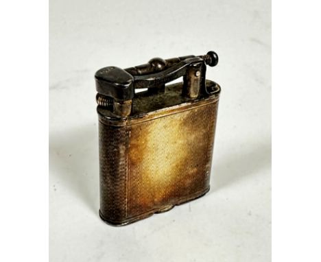 A Dunhill silver engine turned cigarette lighter (5cm x 4cm), stamped AD and London 1951 (66.2g)