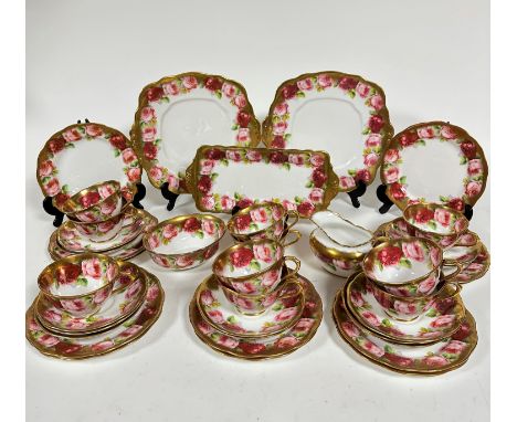 A Royal Albert pink rose and gilt bordered teaset of thirty nine pieces, including two cake plates (23cm), twelve side plates