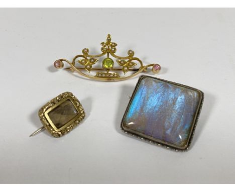 An Edwardian Peridot and seed pearl brooch, stamped 15ct, together with a silver brooch set with butterfly wings, stamped 925