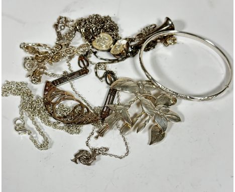 A silver floral drop brooch (6cm), a silver engraved bangle (d.6.5cm), a silver trumpet pendant and silver opening apple, you