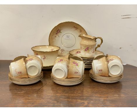 An Edwardian china tea service, comprising twelve cups and saucers, twelve side plates, two serving plates, milk jug and basi