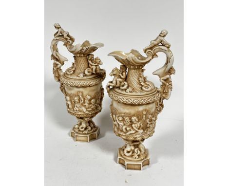 A pair of late 19thc Rudolstadt Straus  &amp; Sohne ewers, the handles mounted with cherubs with mask figure handles with sce