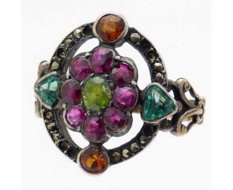 French ruby, emerald and marcasite ring, 19th century, the oval setting of a central peridot surrounded by eight rubies and a