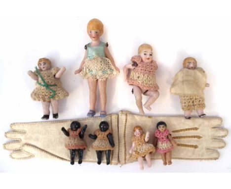 Eight miniature bisque dolls Hertwig or Carl Horn, with jointed legs and arms, also a pair of dolls gloves, the tallest doll 