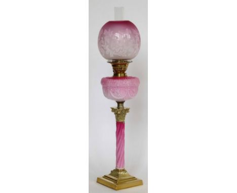 Corinthian column table oil lamp, the twist opaque pink glass stem and reservoir under a frosted globe, height to burner 59cm