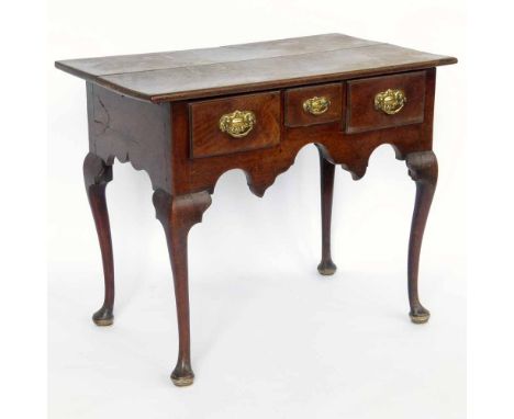 Walnut side table of three apron drawers and a shaped frieze on cabriole legs and pad feet, width 84cm.