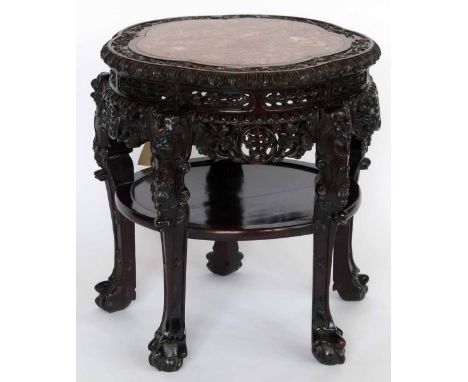 Chinese Qing carved hardwood foliate table, the inset red marble top over a uniting lower shelf, diameter 56cm.
