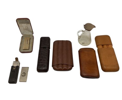 A silver topped whisky noggin together with a collection of cigar cases and two Dunhill lighters. 