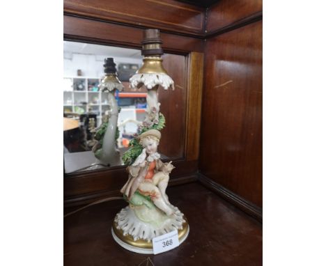 1900s Italian table lamp with boy holding bird marked N with a crown Italy. 