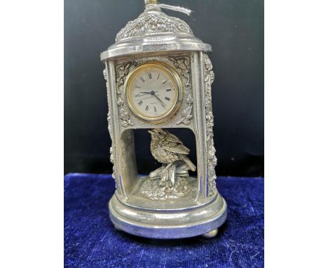 Silver Hall marked birmingham mantle clock makers mappin and Webb with small bird decor.