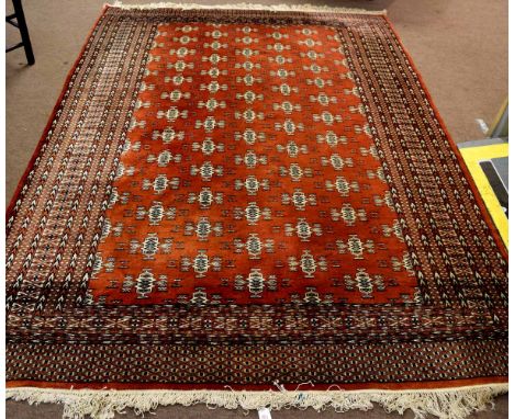 Modern Bokhara type carpet with rust ground and geometric repeating lozenge on a multi-gulled border, 193cms wide x 285cms lo