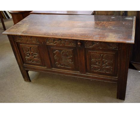 18th century oak coffer with three carved panel front on planked legs, 137cms wide x 61cms deep x 77cms high  