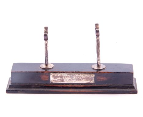 Ebonised and silver pen holder, rectangular step ebonised base with two silver rowlocks and engraved with a presentation plaq