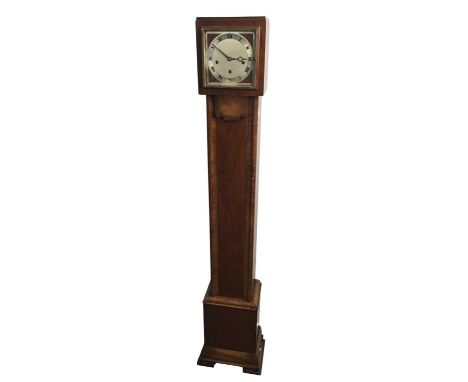 ART DECO WALNUT GRANDMOTHER CLOCK, CIRCA 1930 the silvered circular dial with numerals in black, the base with splayed bracke