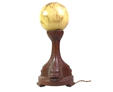 ART DECO TABLE LAMP, with marbled spherical glass shade on a wooden trefoil base45cm highThe shade is in good overall conditi