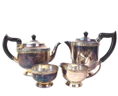SILVER PLATED FOUR PIECE TEA SERVICE, ALONG WITH A PAIR OF SILVER NAPKIN RINGS  the napkin rings with Birmingham marks (rubbe