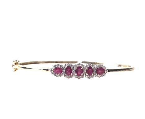 RUBY AND ZIRCON BANGLE, set with a central spray cluster of rubies and zircon stones, in nine carat goldQty: 8.8g