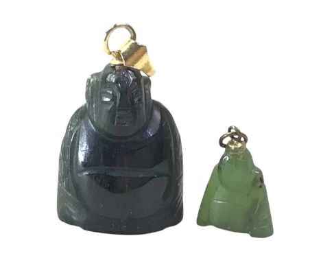 TWO NEPHRITE JADE PENDANTS, in the form of Buddhas, one larger in formQty: 2