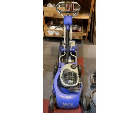A Victa Razor  VSX160 petrol driven lawn mower, model RMA271A, with grass box and instructions. 