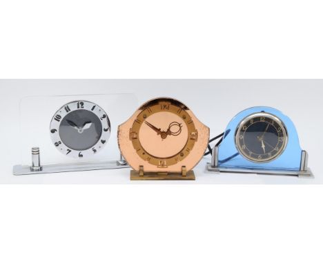 An English Art Deco 8 day mantel clock, having chromed chapter ring with Arabic numerals, set in a clear perspex backplate, r
