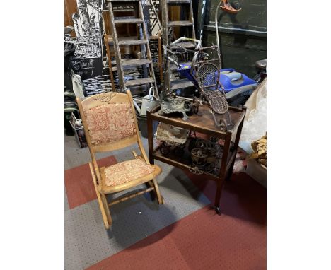 A satin wood folding rocking chair, together with a two tier tea trolley, dolls prams and a cast iron stick stand