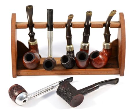 A collection of smokers pipes, makers to include Parker, Petersons, Falcon and Alco, together with a pipe stand. 