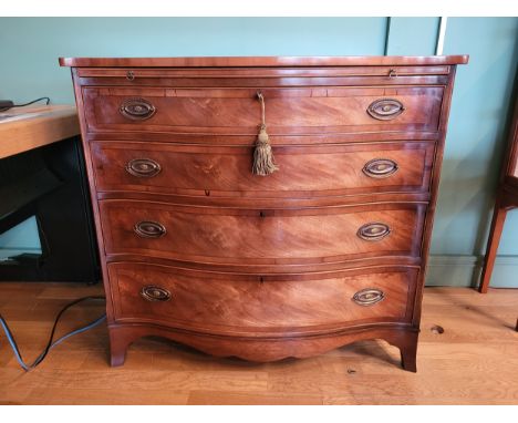 Bevan Funnell Ltd England; A George III style mahogany and walnut serpentine fronted chest of drawers, with slide and shaped 