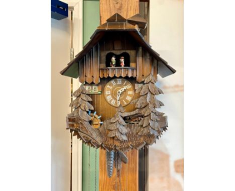 A mid 20th century Black Forest cuckoo clock, in the form of a Swiss chalet, having triple chain German movement, automated f