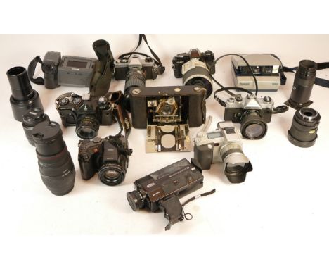 A collection of mixed cameras and accessories to include five lenses, two digital cameras, two polaroid and four vintage film