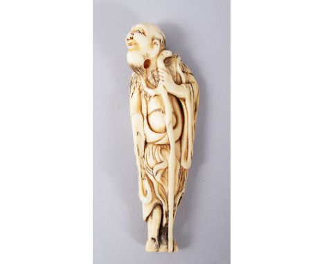 A GOOD JAPANESE EDO PERIOD CARVED IVORY NETSUKE OF A SENNIN, stood holding his staff, 8.6cm.