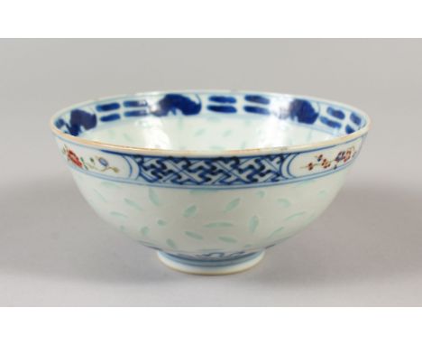 A 19TH CENTURY CHINESE BLUE &amp; WHITE &amp; ENAMEL DECORATED RICE PATTERN PORCELAIN BOWL, the interior painted to its centr