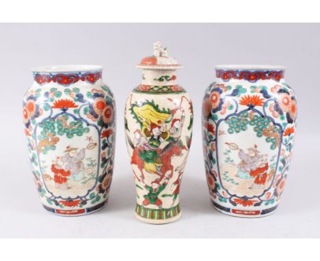 TWO 19TH CENTURY JAPANESE IMARI PORCELAIN VASES, the imari vases decorated with panels of figures within garden settings, fur