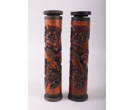 A GOOD PAIR OF CHINESE BAMBOO JOSS STICK HOLDERS, carved with scenes of figures amongst woody &amp; rocky outcrops, early 20t