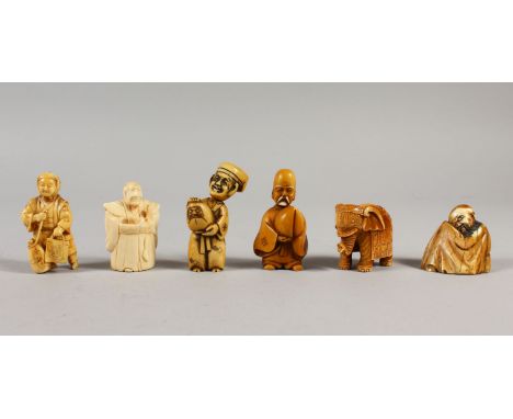 A GROUP OF SIX JAPANESE CARVED IVORY NETSUKE / OKIMONO depicting a warrior, an elephant, one holding daruma doll, and three o