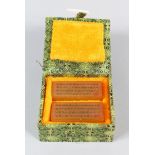 A PAIR OF CHINESE AMBER SOAPSTONE SEALS, in fitted box, engraved character inscription, each measure